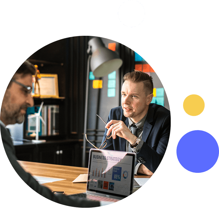 Two colleagues reviewing marketing performance data on a laptop